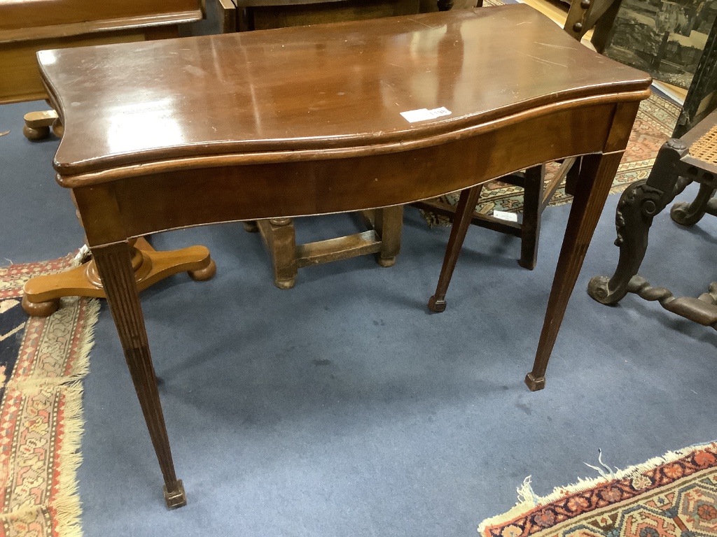 A George III style mahogany serpentine folding card table, width 87cm, depth 44cm, height 74cm